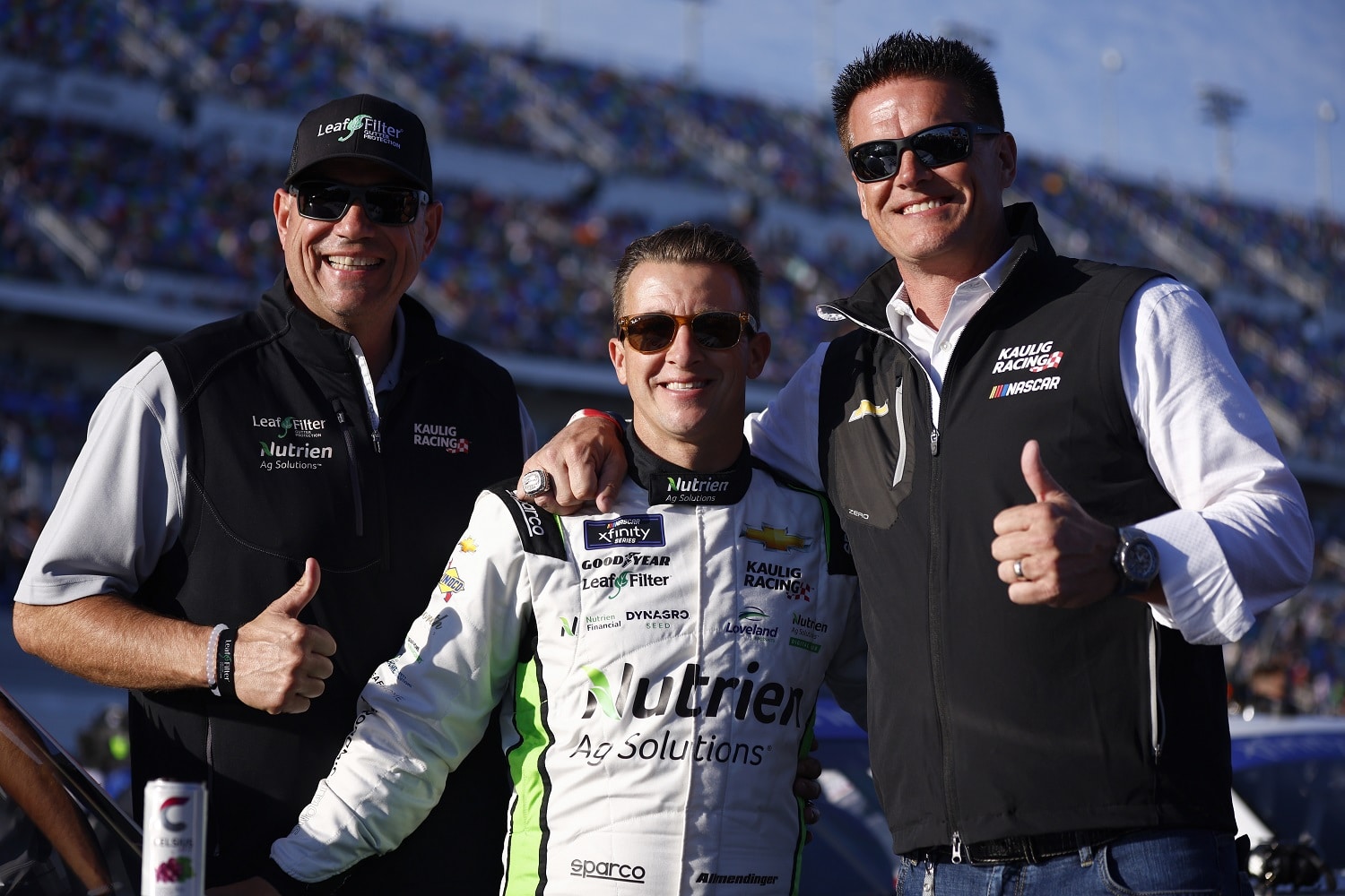 Team president Chris Rice and owner Matt Kaulig flank driver AJ Allmendinger after the NASCAR Xfinity Series race at Daytona International Speedway on Feb. 19, 2022.