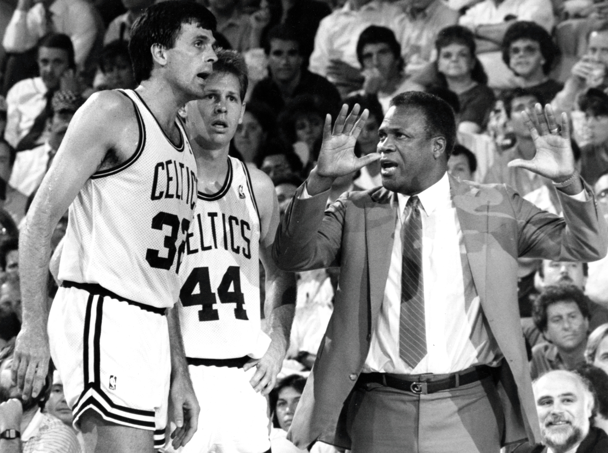 Boston Celtics head coach K.C. Jones gestures as he talks with players Kevin McHale, left, and Danny Ainge.