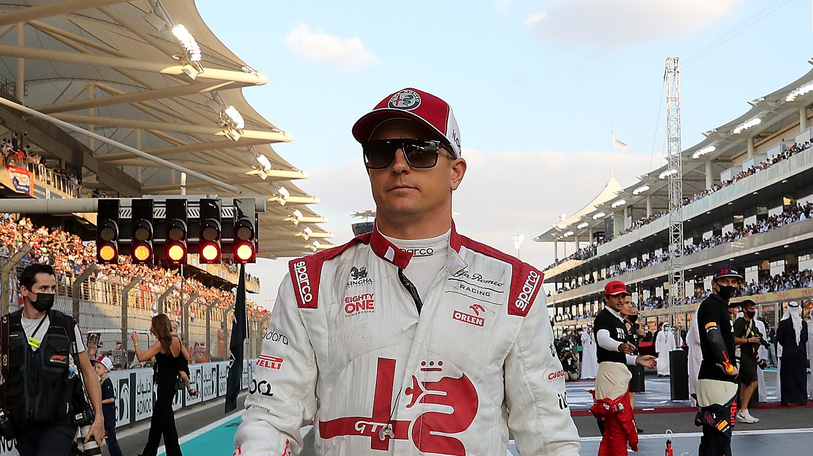 Kimi Raikkonen of Finland and Alfa Romeo Racing walks on the grid prior to the Formula 1 Grand Prix of Abu Dhabi at Yas Marina Circuit on Dec. 12, 2021, in Abu Dhabi, United Arab Emirates.