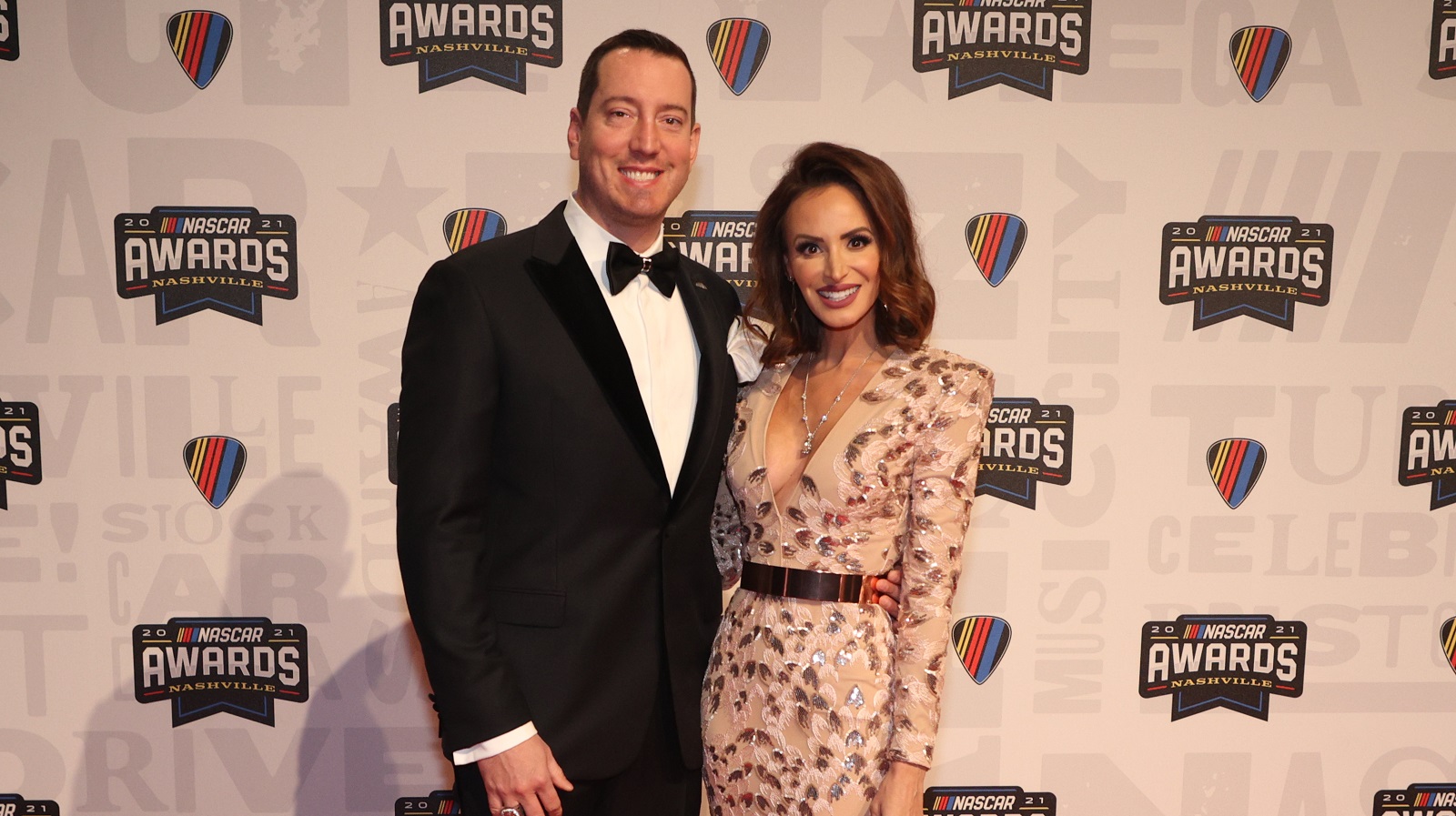 NASCAR Cup Series driver Kyle Busch and wife Samantha Busch pose on the red carpet prior to the NASCAR Champion's Banquet at the Music City Center on Dec. 2, 2021, in Nashville, Tennessee.
