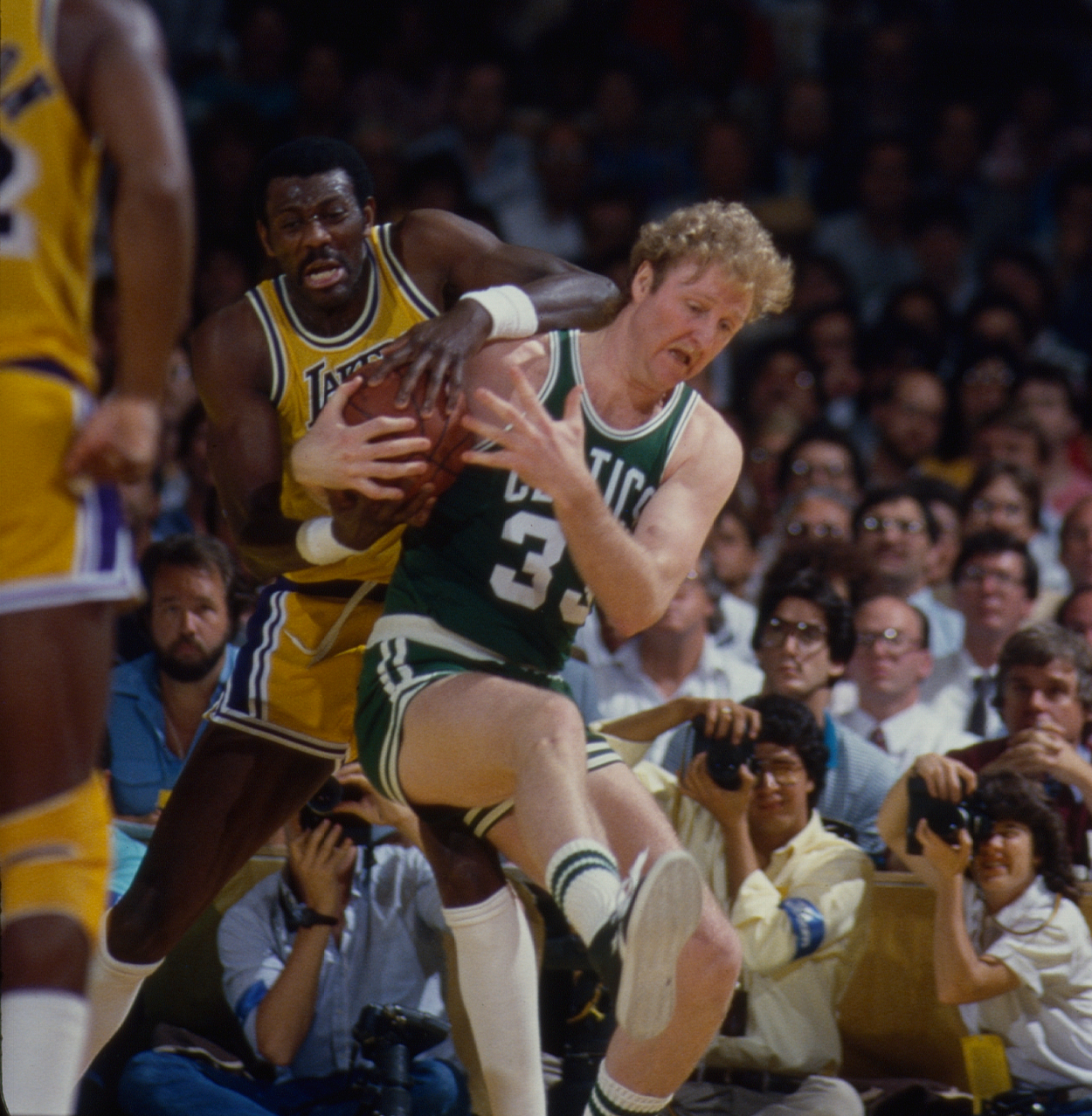 Los Angeles Lakers Bob McAdoo battles Boston Celtics Larry Bird for the ball.