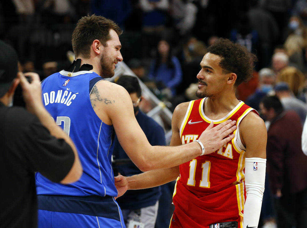 Luka Doncic talks with Trae Young after a game.