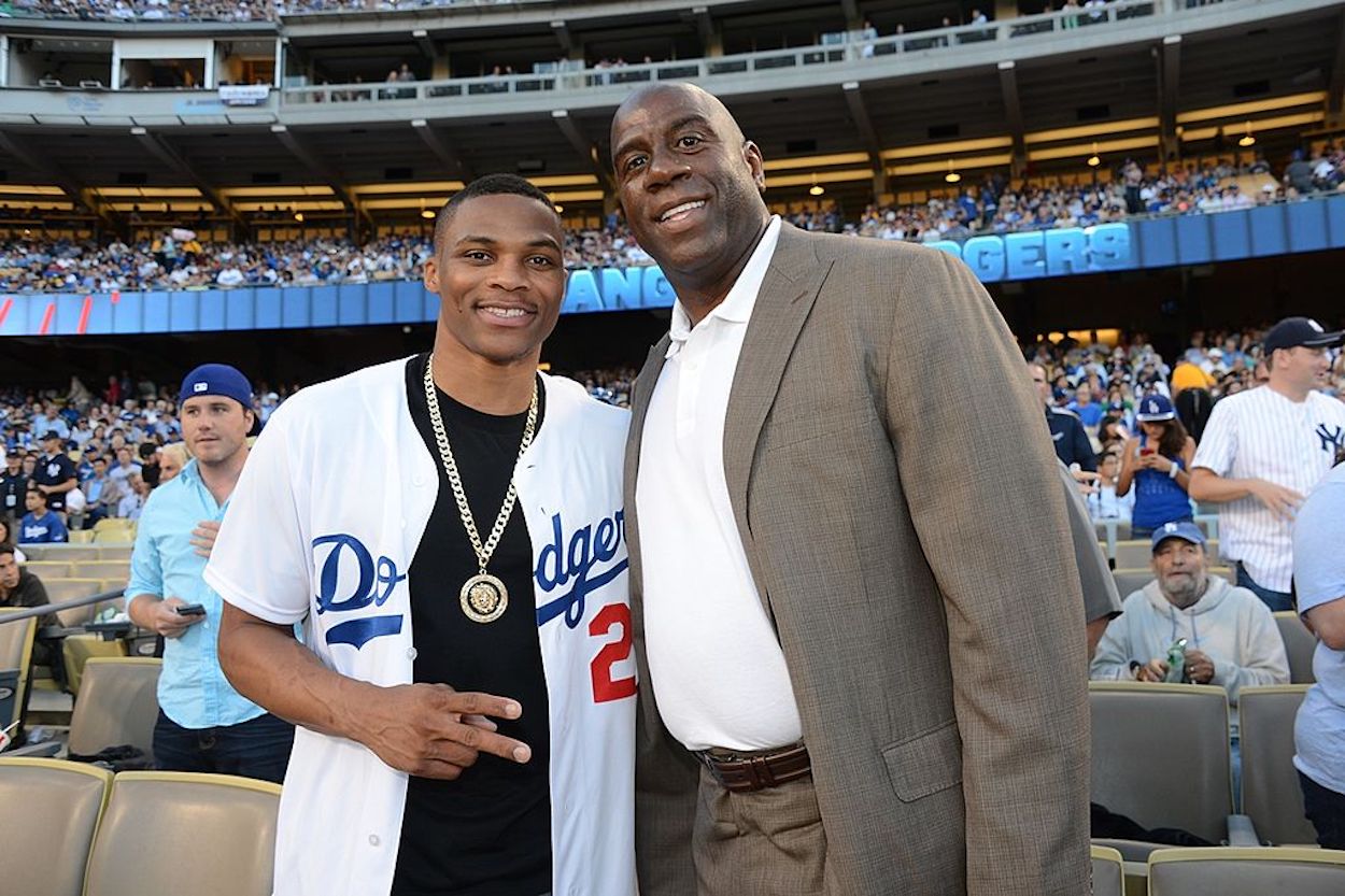 Russell Westbrook and Magic Johnson pose at a Los Angeles Dodgers game.
