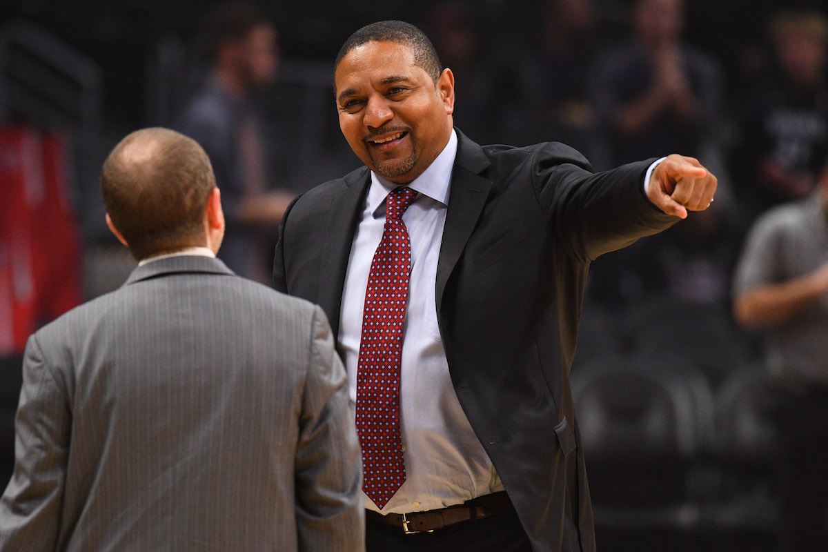 ESPN announcer Mark Jackson jokes with President of Basketball Operations Lawrence Frank before an NBA game