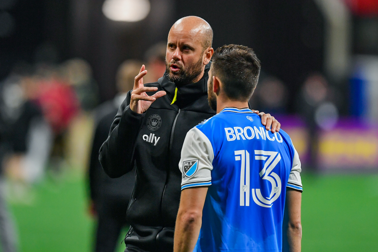 Former Charlotte head coach Miguel Ángel Ramírez talks with Charlotte midfielder Brandt Bronico.
