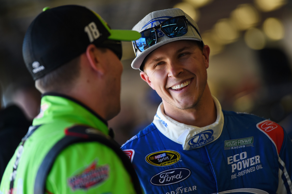 Trevor Bayne talks with Kyle Busch in the garage during practice for the 2015 Daytona 500