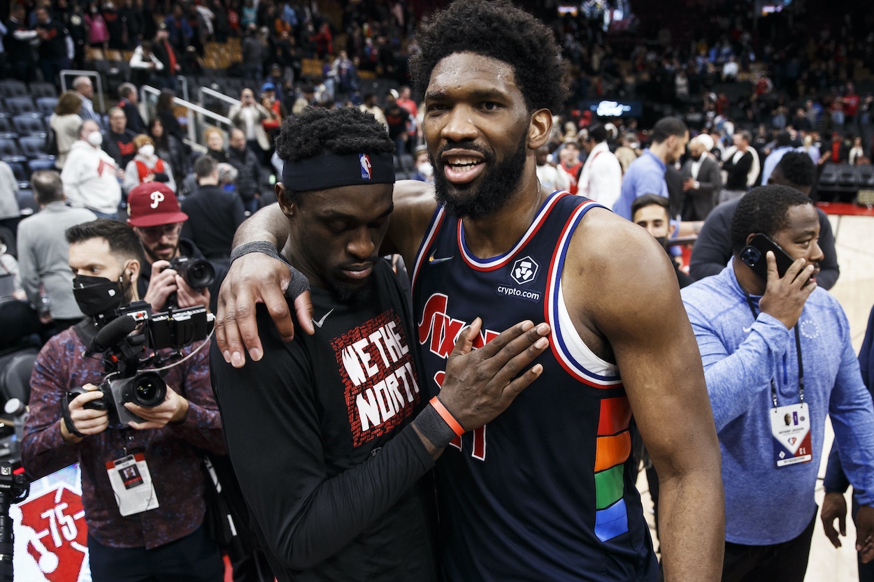 Joel Embiid embraces Pascal Siakam.