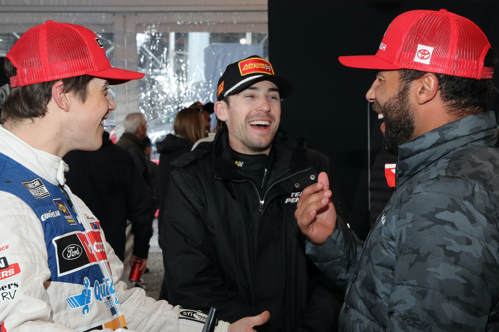 Ryan Blaney and Bubba Wallace laugh with Harrison Burton