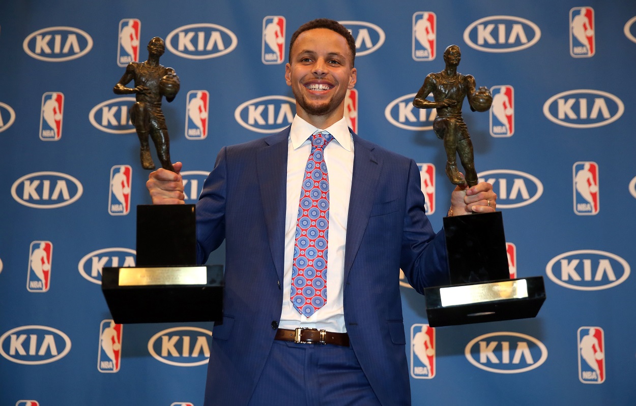 Stephen Curry poses with his two NBA MVP trophies