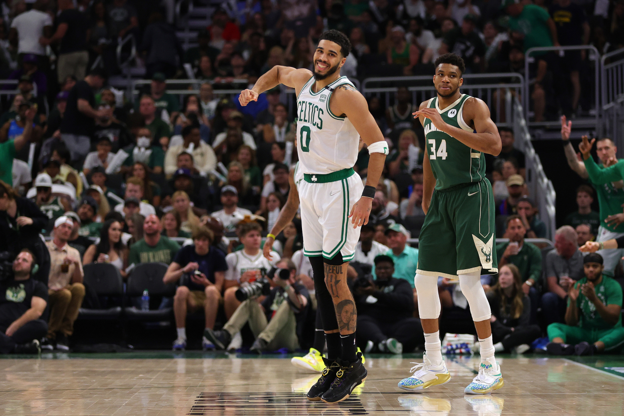 Jayson Tatum of the Boston Celtics celebrates a basket against Giannis Antetokounmpo of the Milwaukee Bucks.