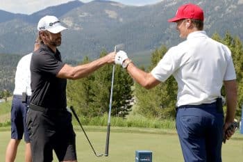 Aaron Rodgers and Tom Brady fist bump during Capital One's The Match.
