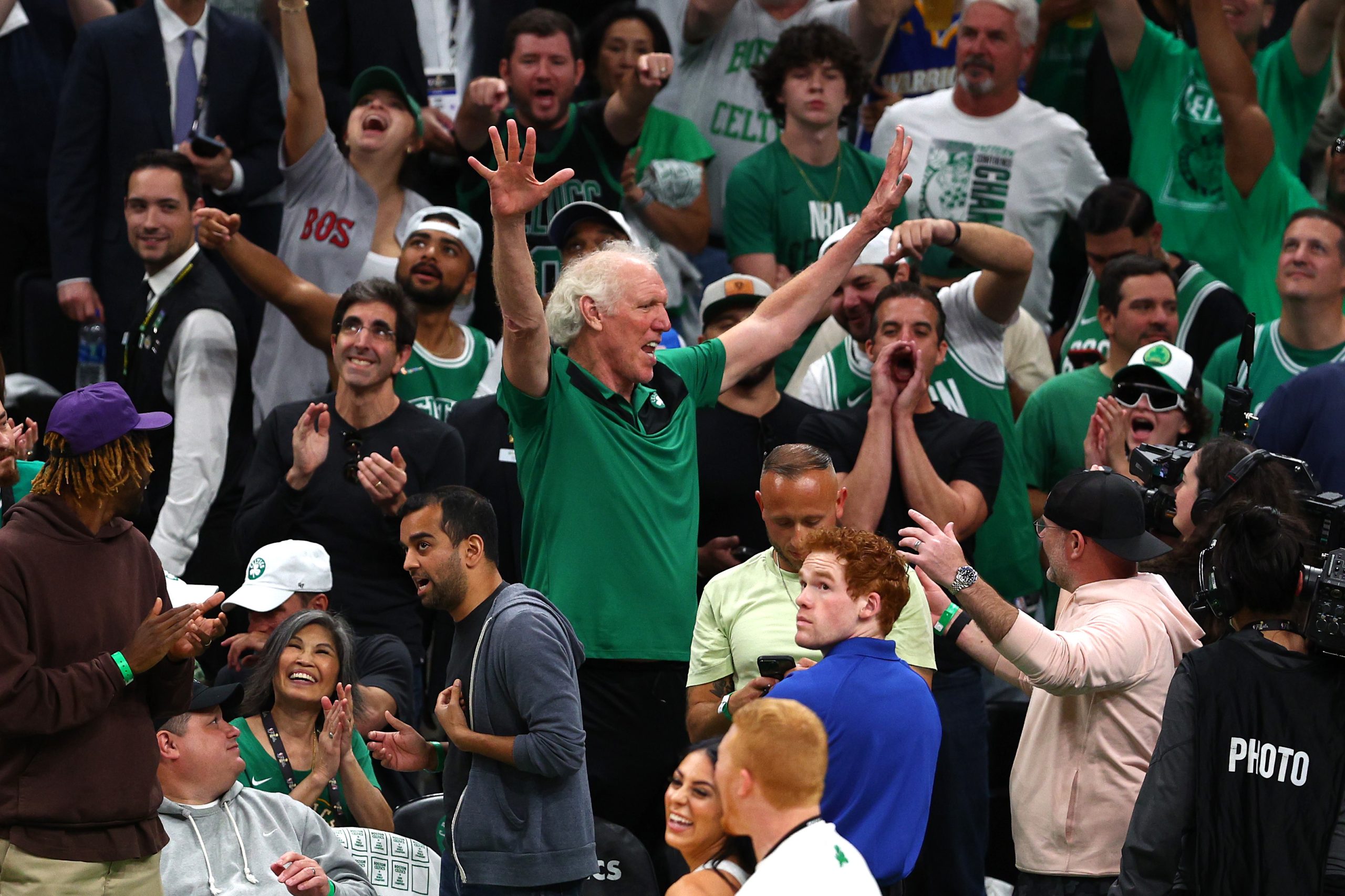 Former Boston Celtics player Bill Walton waves to fans in the crowd in the second quarter against the Golden State Warriors.