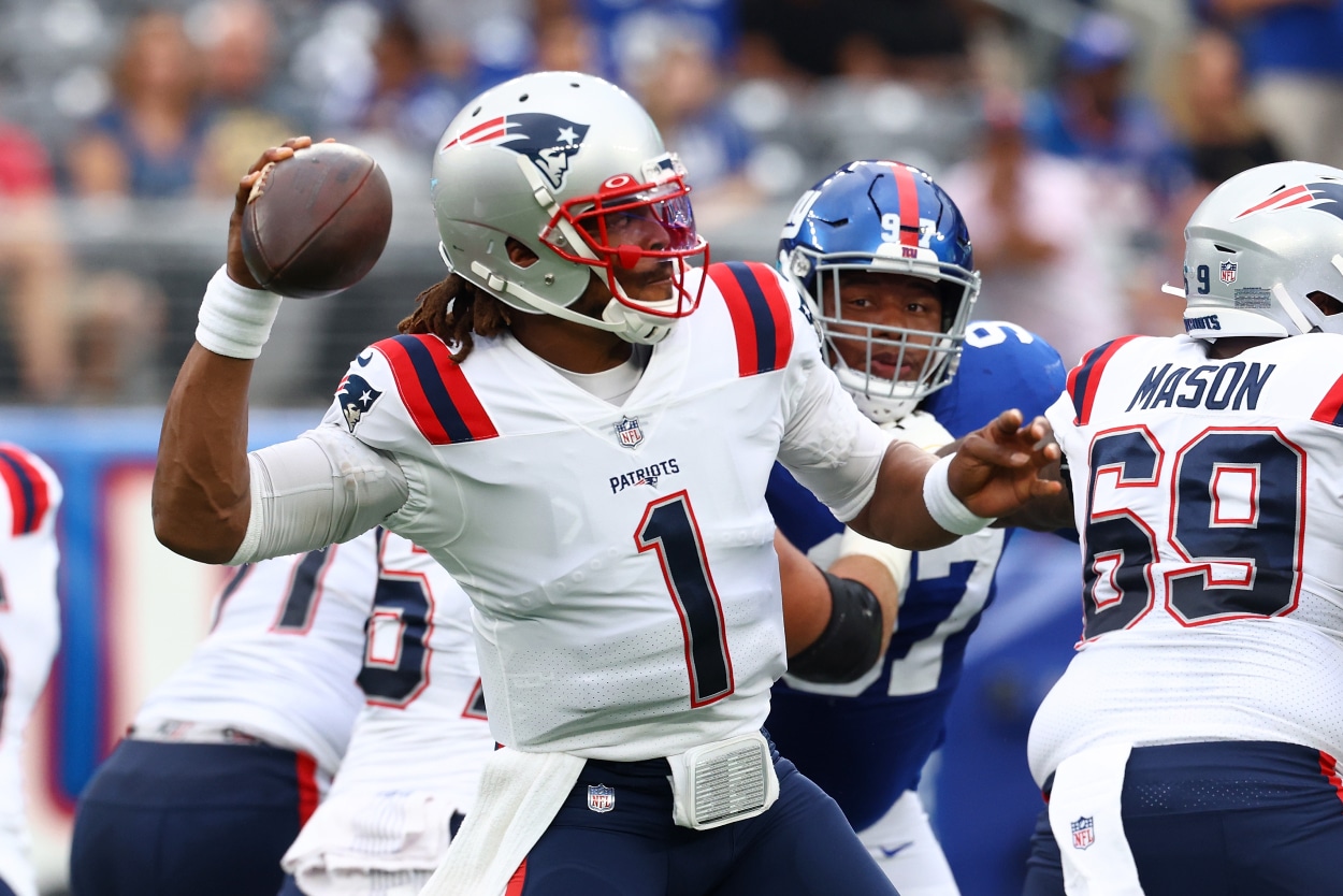 Cam Newton of the New England Patriots looks to pass.