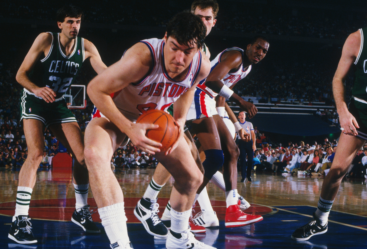 Detroit Pistons center Bill Laimbeer takes the ball during the NBA playoffs against the Boston Celtics.