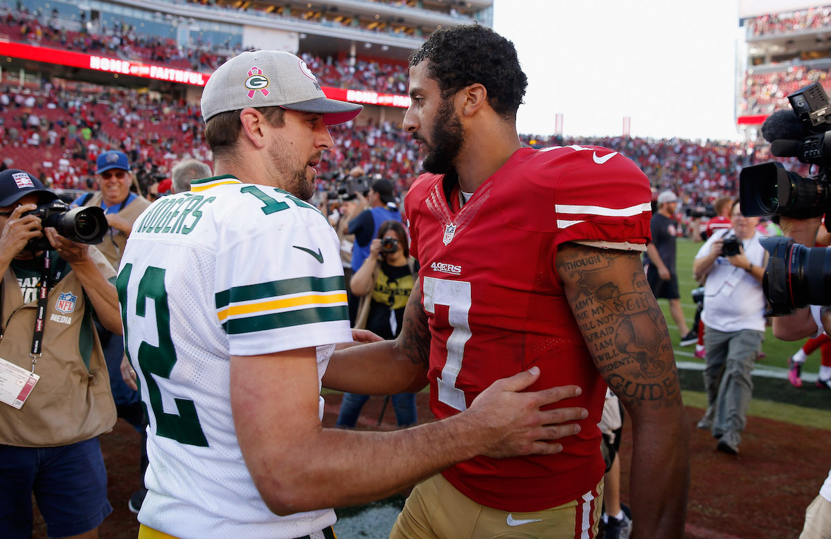 Colin Kaepernick of the San Francisco 49ers talks with Aaron Rodgers of the Green Bay Packers after a game in 2015