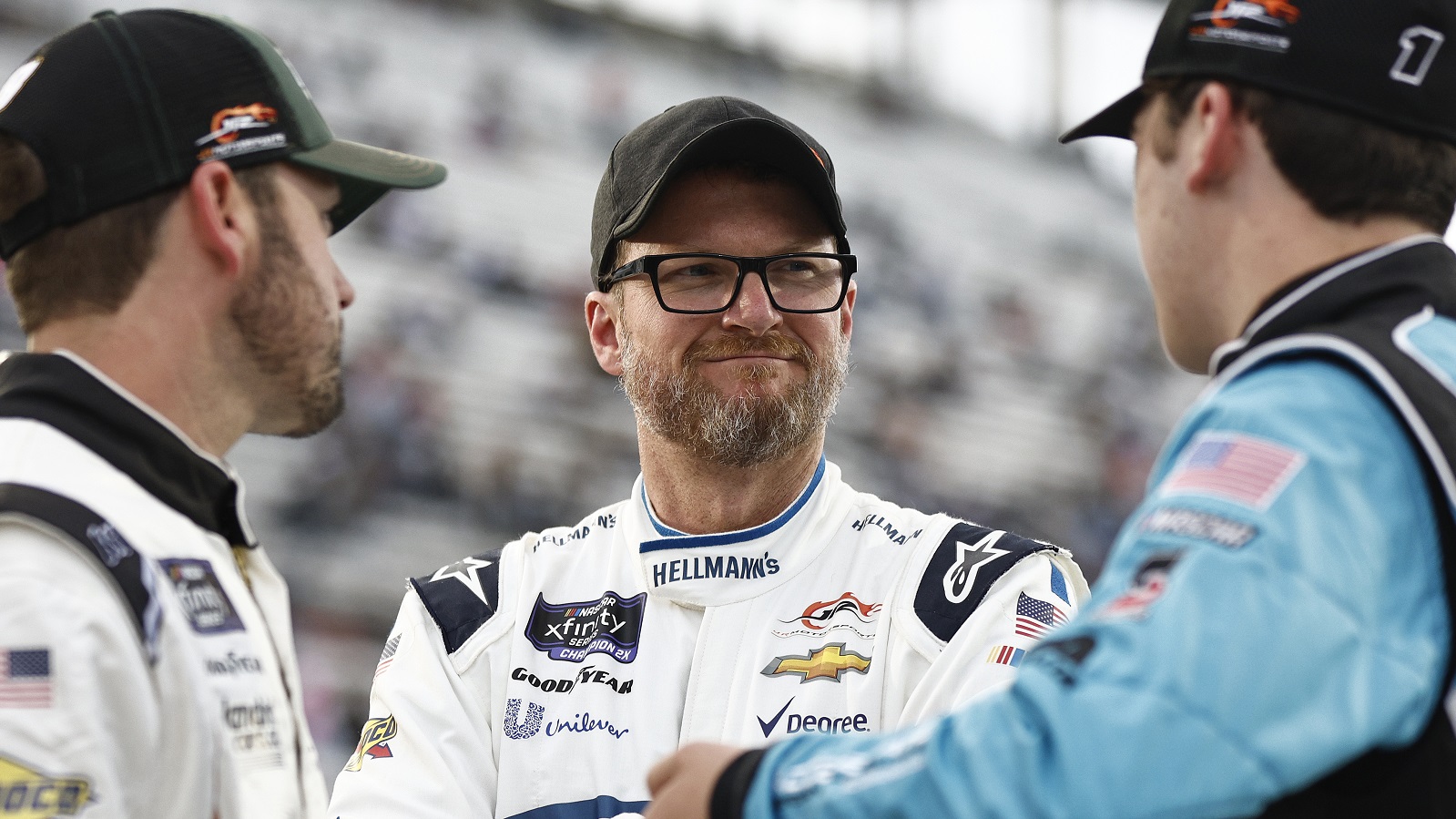 Dale Earnhardt Jr., center, speaks with Josh Berry and Sam Mayer on the grid during qualifying for the NASCAR Xfinity Series Call 811 Before You Dig 250 at Martinsville Speedway on April 7, 2022.