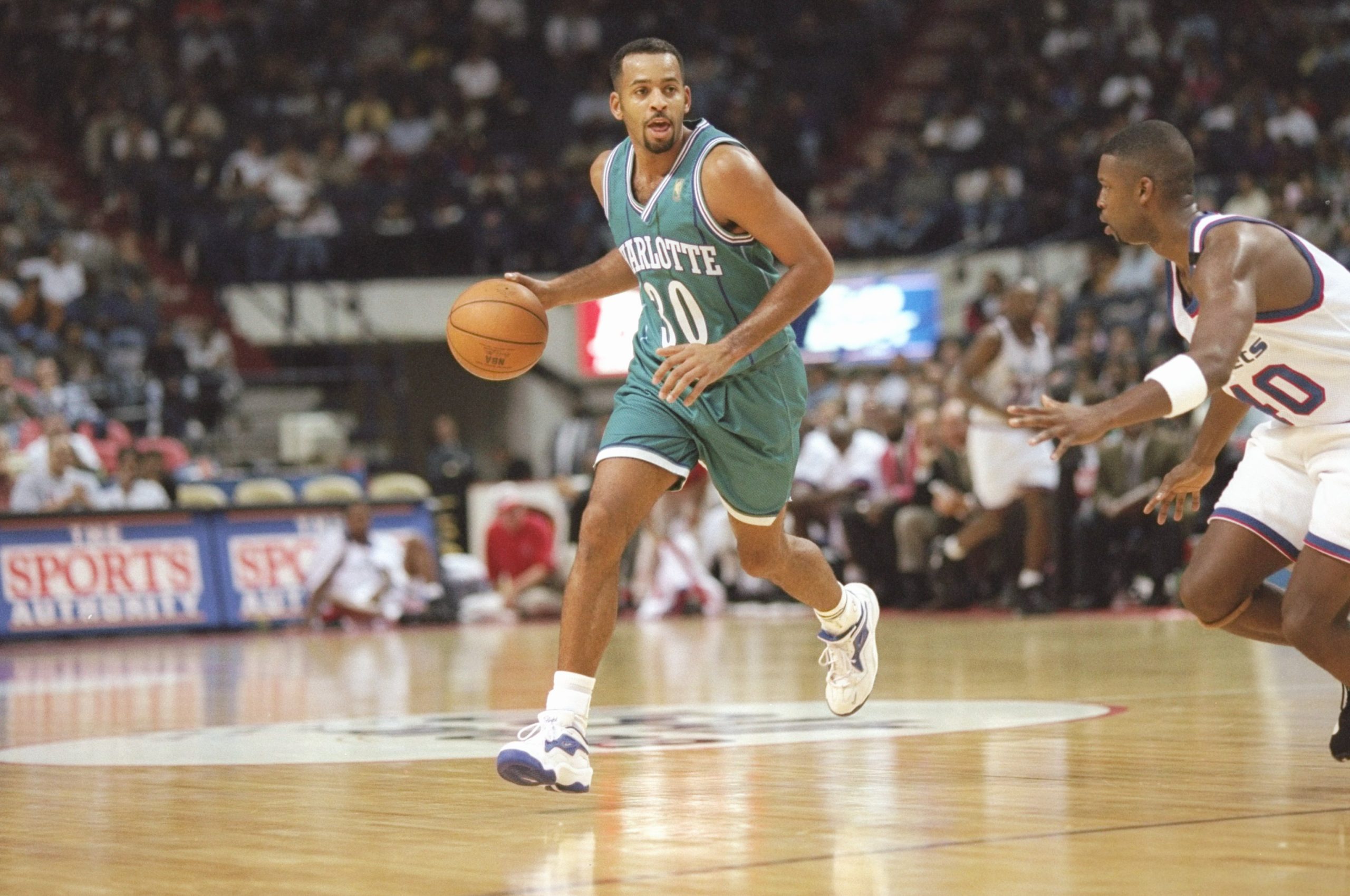 Guard Dell Curry of the Charlotte Hornets dribbles the ball down the court.