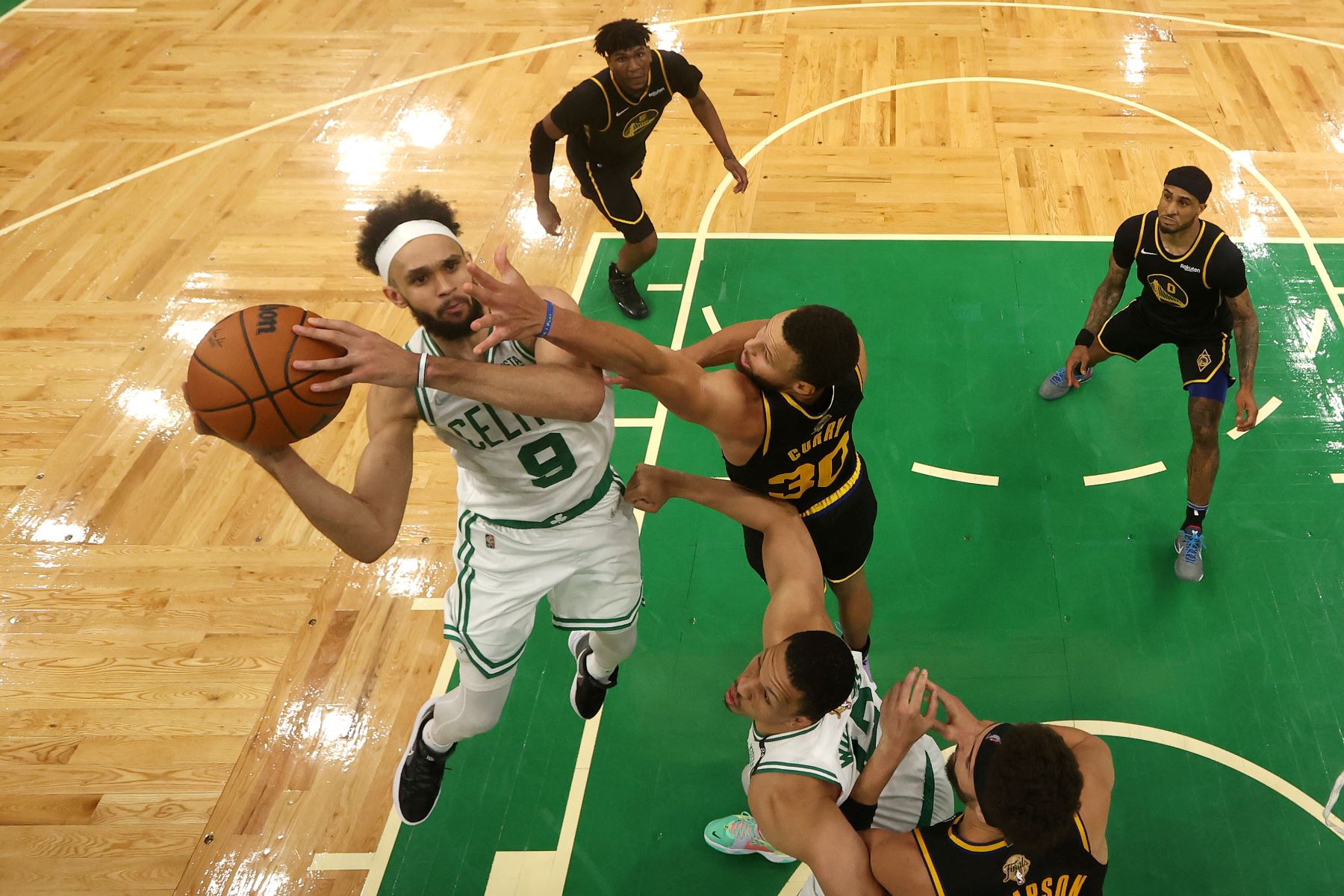 Derrick White of the Boston Celtics shoots against Stephen Curry of the Golden State Warriors during 2022 NBA Finals