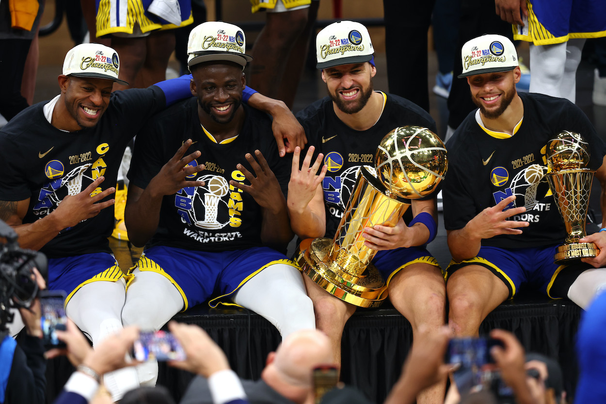 Andre Iguodala, Draymond Green, Klay Thompson, and Stephen Curry of the Golden State Warriors pose for a photo after defeating the Boston Celtics 103-90 in Game Six of the 2022 NBA Finals.