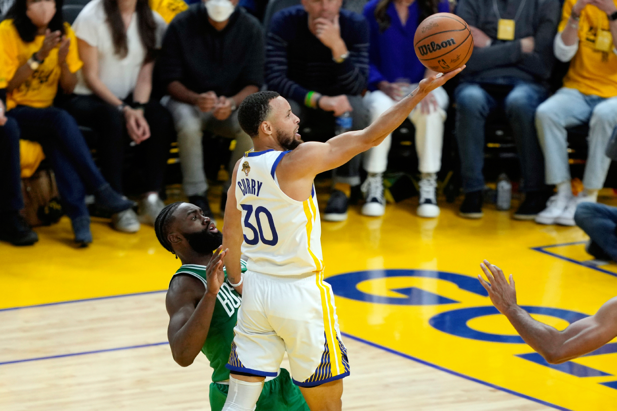 Stephen Curry of the Golden State Warriors shoots the ball against Jaylen Brown of the Boston Celtics.