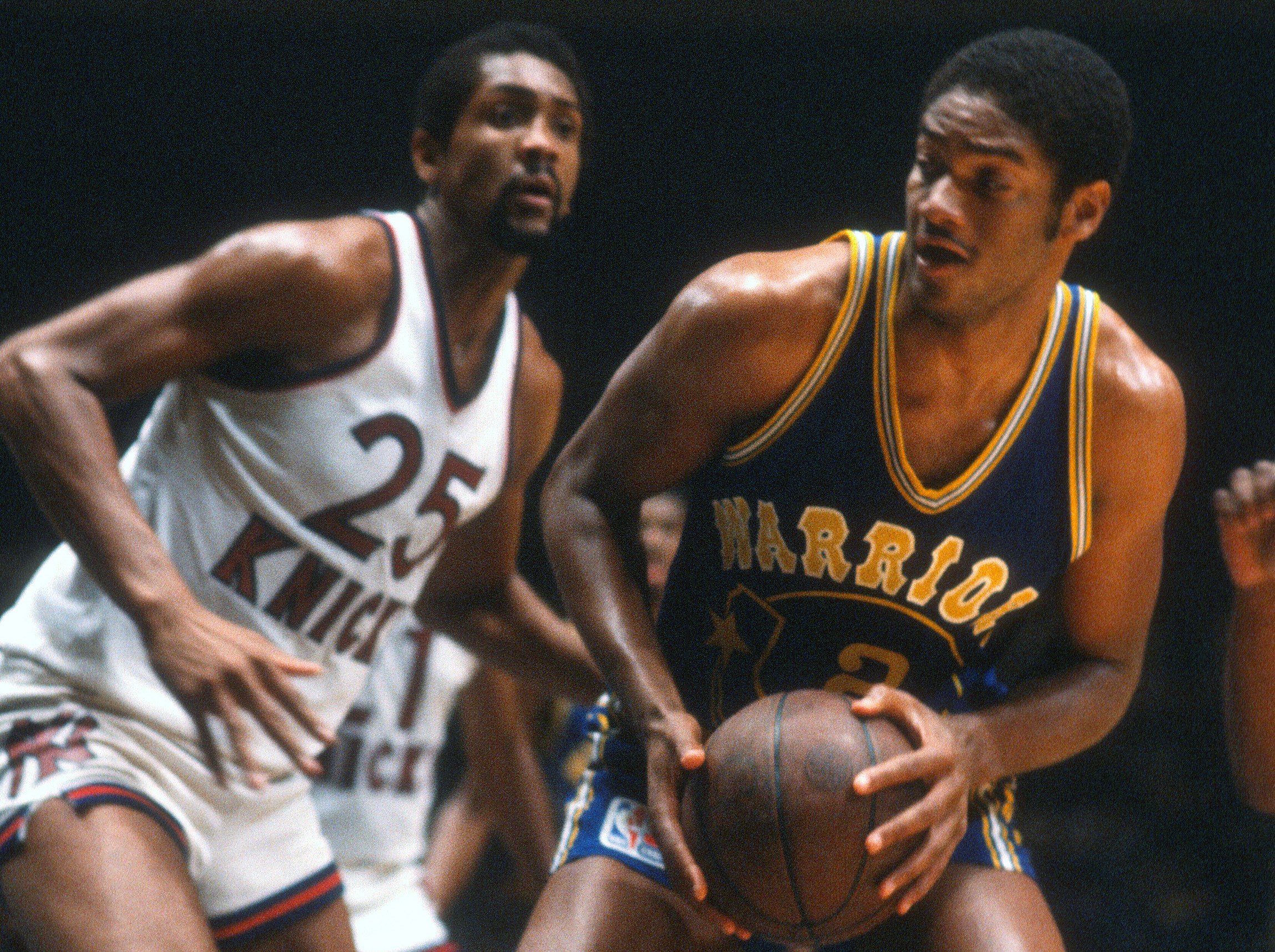 Joe Barry Carroll of the Golden State Warriors controls the ball while guarded by Bill Cartwright.