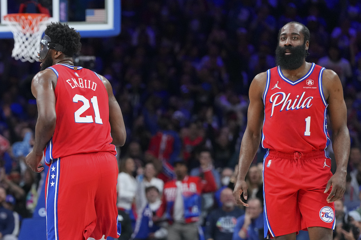 Joel Embiid and James Harden look on during a game.