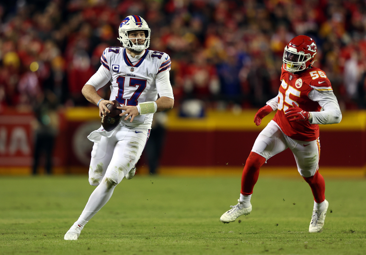 Quarterback Josh Allen of the Buffalo Bills scrambles while being chased by defensive end Frank Clark of the Kansas City Chiefs.