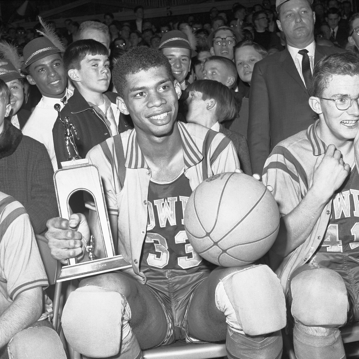 Power Memorial High School player Lew Alcindor proudly displays his MVP trophy and the game basketball in 1965