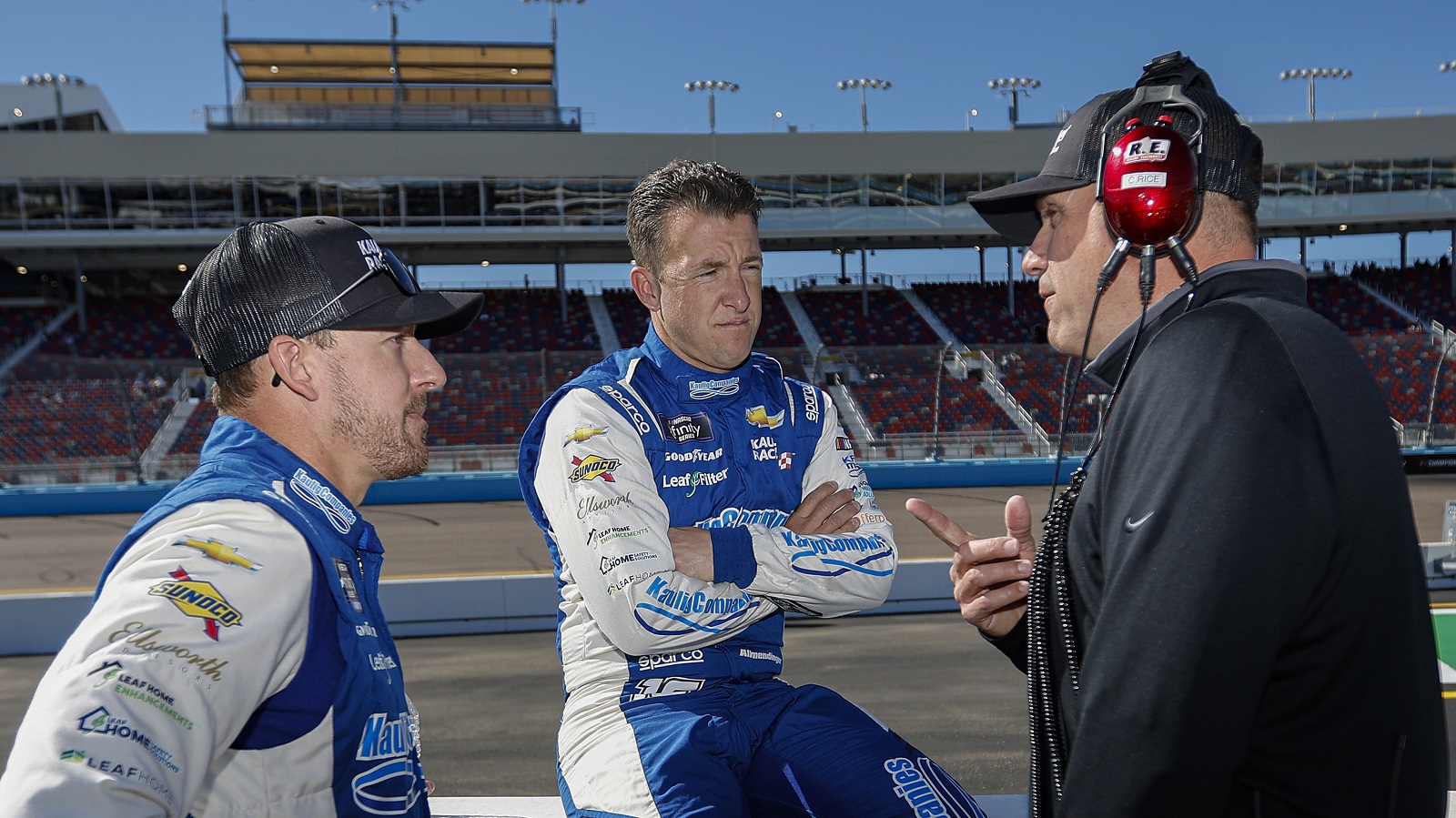 Drivers Daniel Hemric and AJ Allmendinger speak with and Chris Rice, president of Kaulig Racing, on the grid during qualifying for the NASCAR Xfinity Series United Rentals 200 at Phoenix Raceway on March 12, 2022.