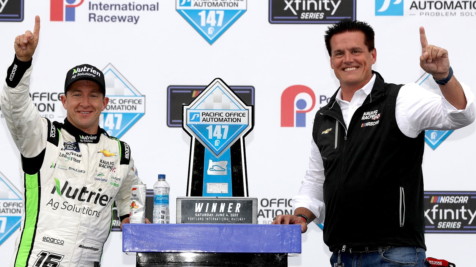 AJ Allmendinger and Matt Kaulig, owner of Kaulig Racing, celebrate in Victory Lane after winning the NASCAR Xfinity Series Pacific Office Automation 147 at Portland International Raceway on June 4, 2022.