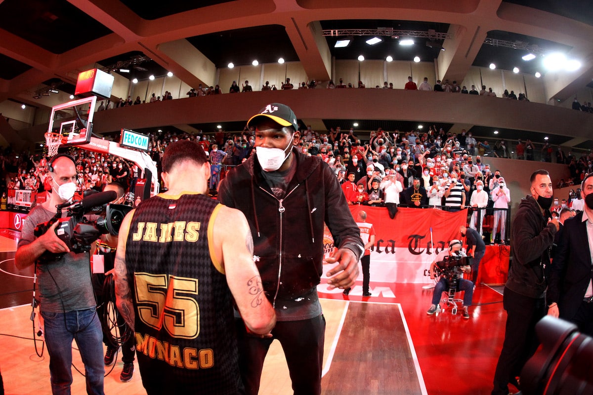 Mike James of AS Monaco celebrates with Kevin Durant after winning a game