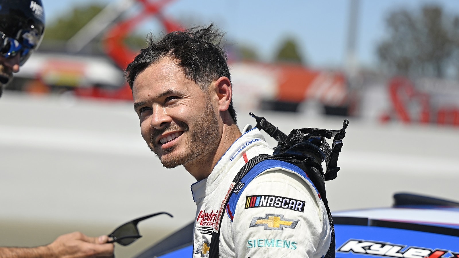 Kyle Larson climbs from the No. 5 Chevy after winning the pole for the NASCAR Cup Series Toyota/Save Mart 350 on June 11, 2022, at Sonoma Raceway.