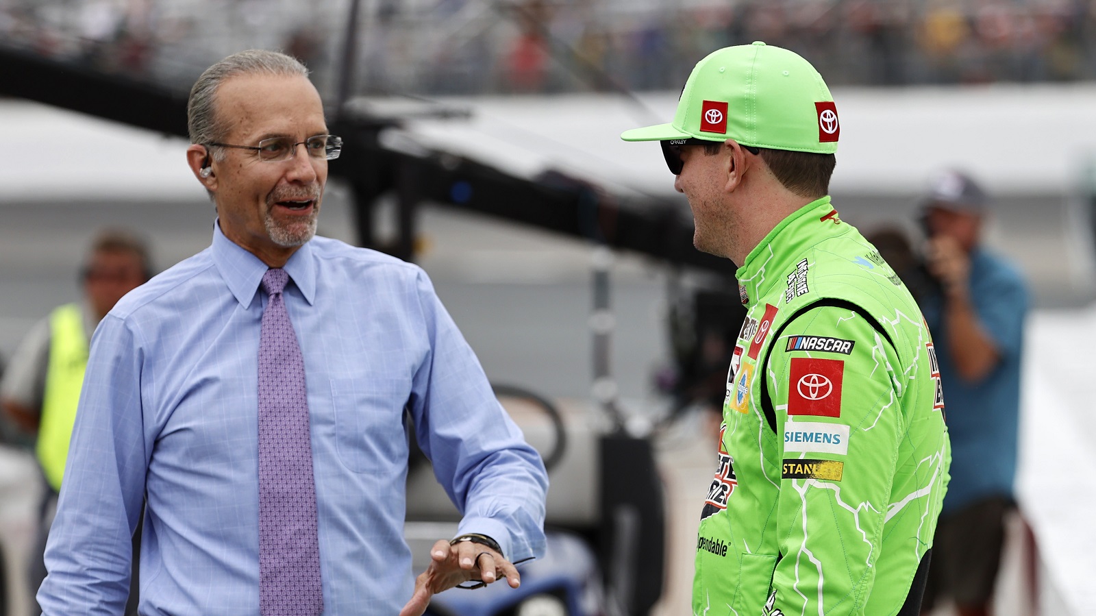 Kyle Petty talks to Joe Gibbs Racing driver Kyle Busch before the Foxwoods Resort Casino 301 on July 18, 2021, at New Hampshire Motor Speedway.