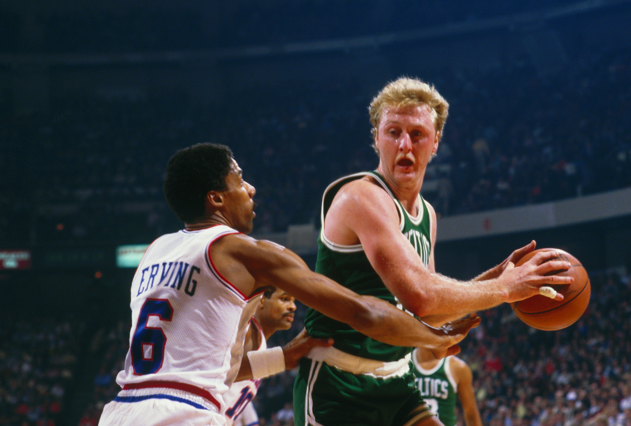 Philadelphia 76ers forward Julius Erving defends against Boston Celtics star Larry Bird.