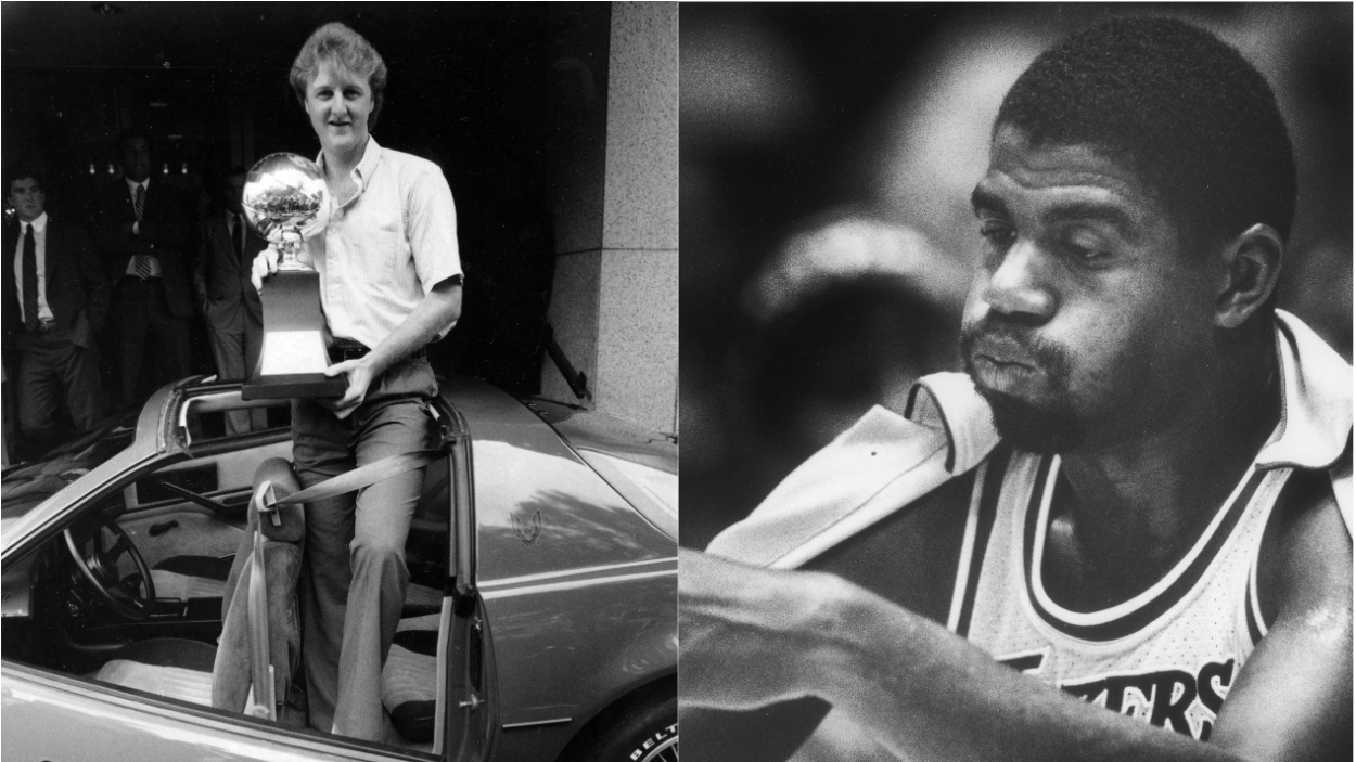 (L-R) Boston Celtics great Larry Bird holds his 1084 NBA Finals MVP Award; LA Lakers star Magic Johnson looks on at the Boston Garden in 1987.