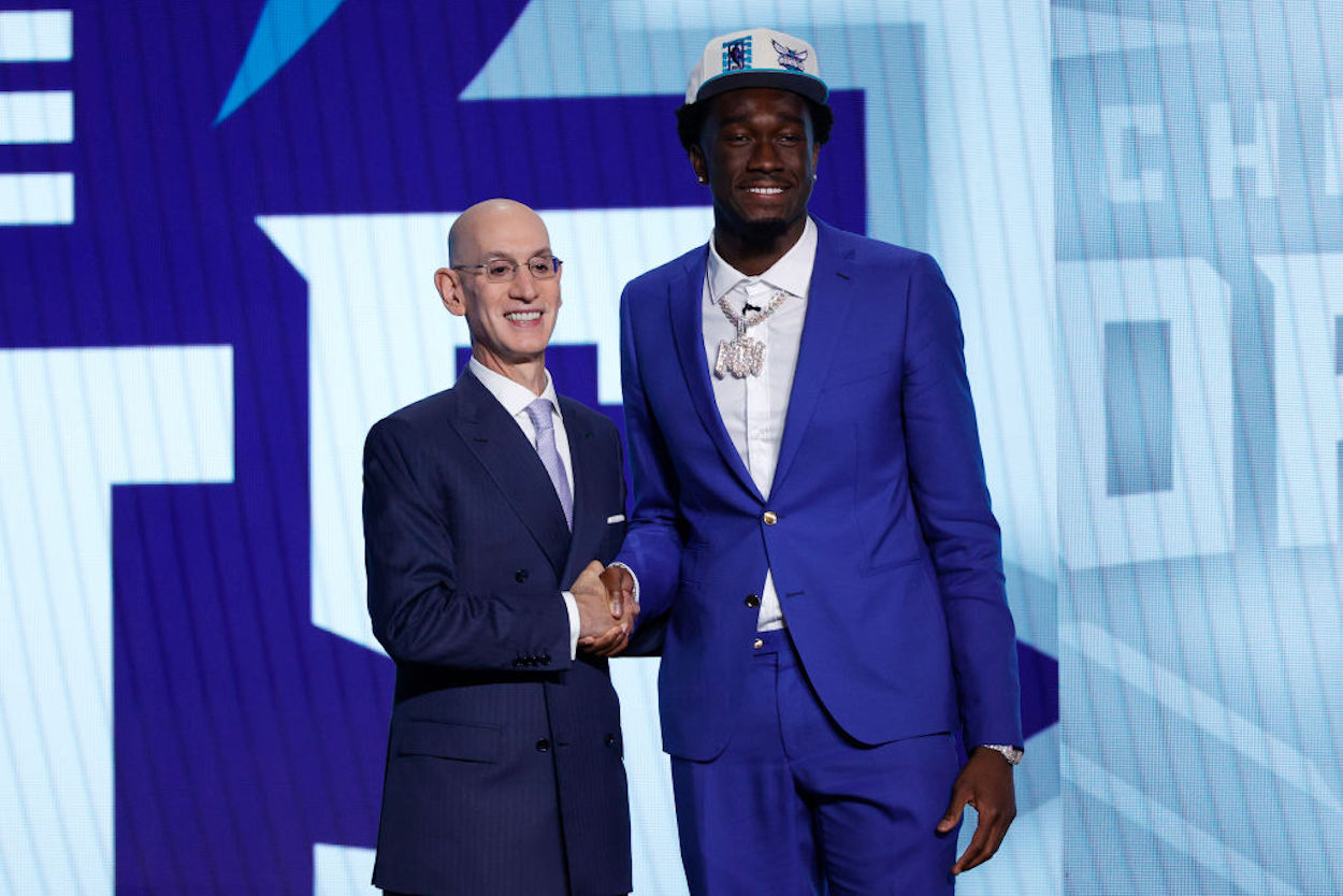 Mark Williams (R) shakes hands with Adam Silver (L) after being drafted by the Charlotte Hornets.