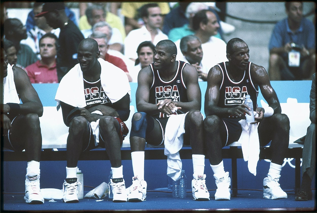 (L-R) Michael Jordan, Magic Johnson, and Clyde Drexler of Team USA, the Dream Team, sit on the bench during the men's basketball competition at the 1992 Summer Olympics in Barcelona, Spain.