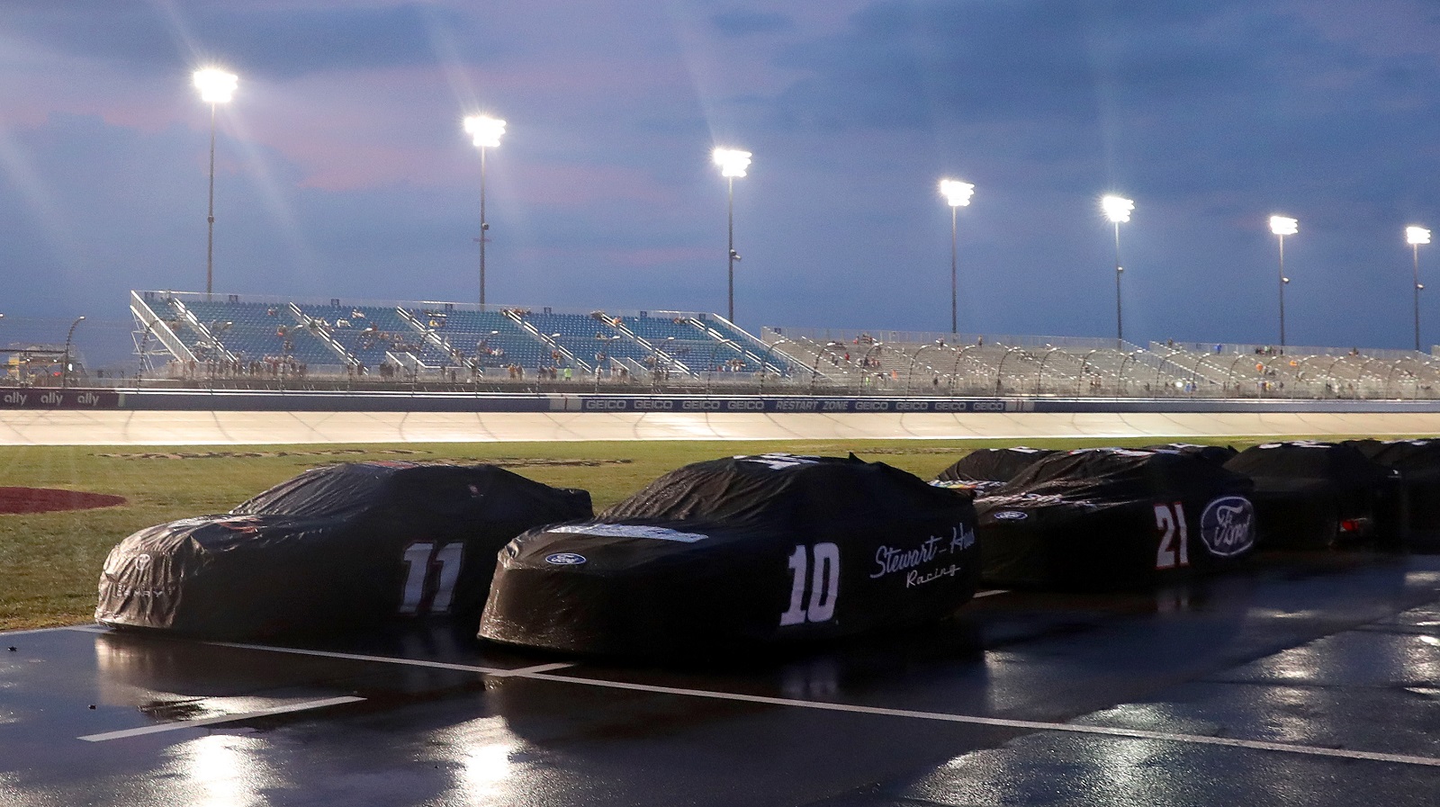 Cars sit covered on the grid during a weather delay in the NASCAR Cup Series Ally 400 at Nashville Superspeedway on June 26, 2022 in Lebanon, Tennessee.