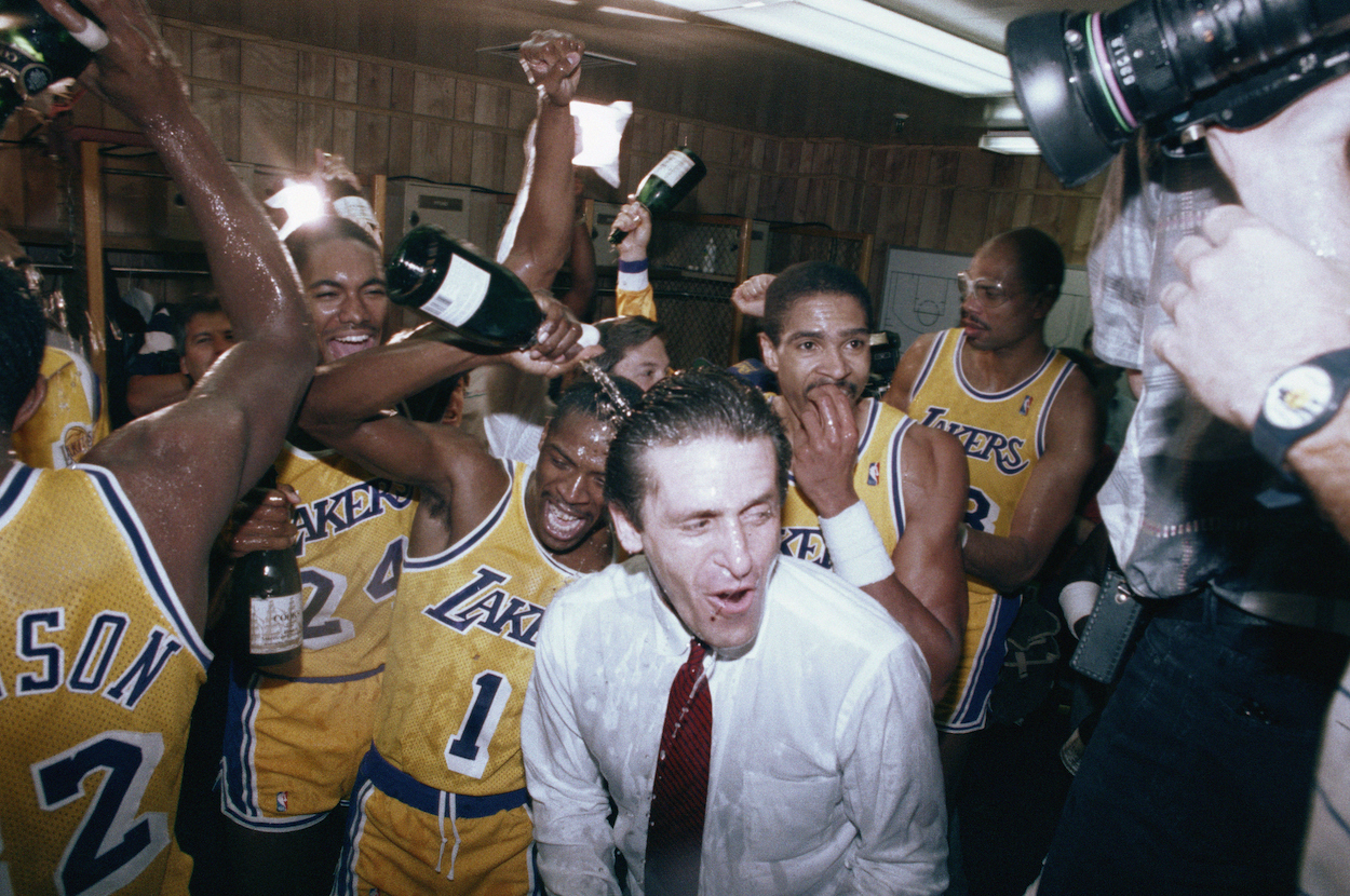 Pat Riley, Magic Johnson and the LA Lakers celebrate their 1985 NBA Finals win over Larry Bird and the Boston Celtics.