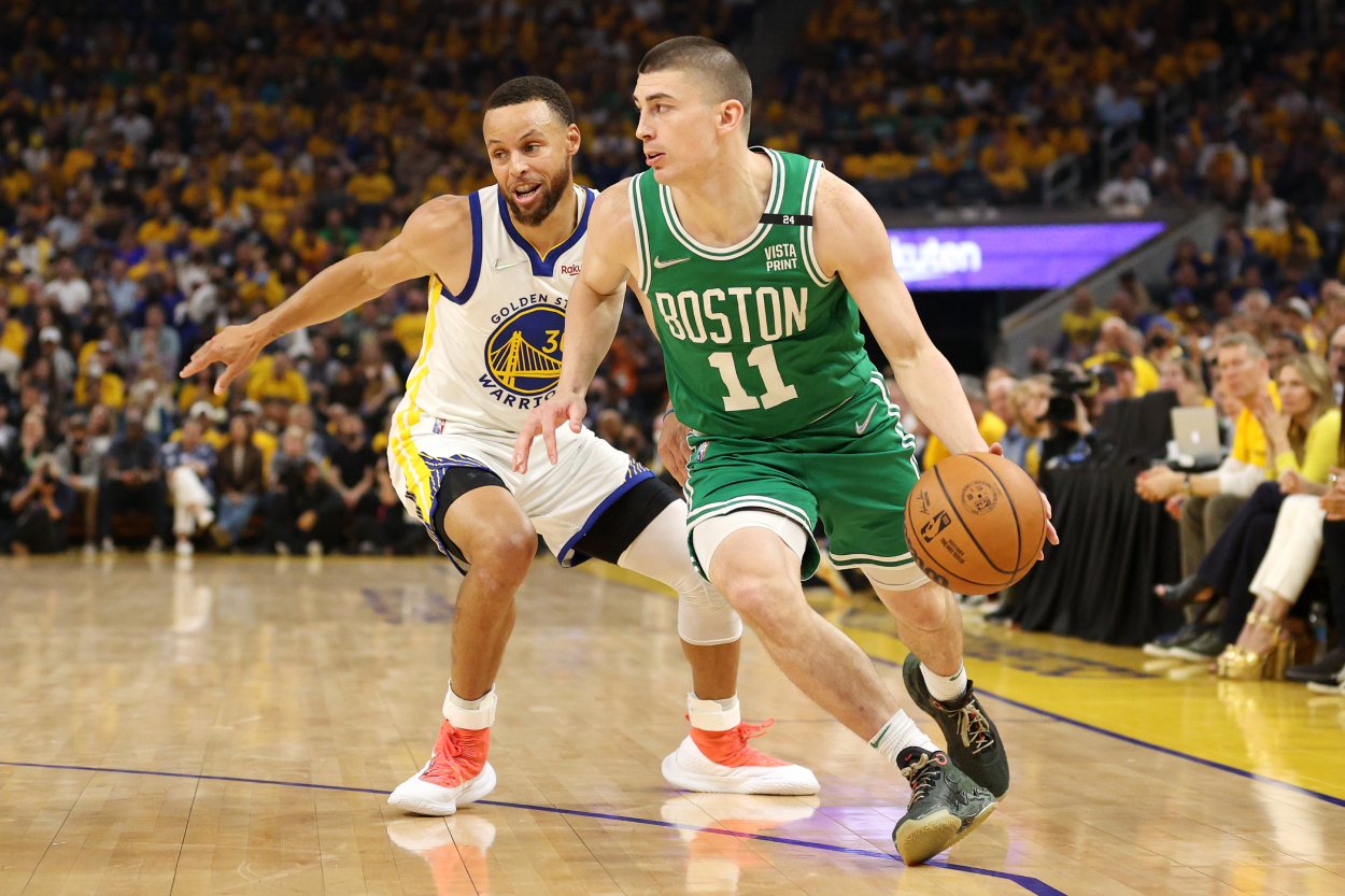 Payton Pritchard of the Boston Celtics drives past Stephen Curry of the Golden State Warriors.