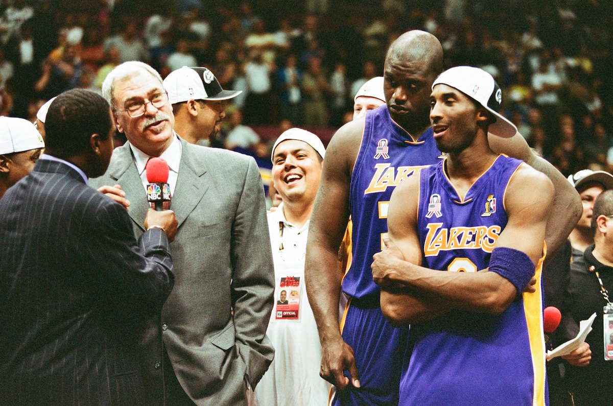 Phil Jackson of the Los Angeles Lakers celebrates with Kobe Bryant and Shaquille O'Neal after winning the 2002 NBA Championship