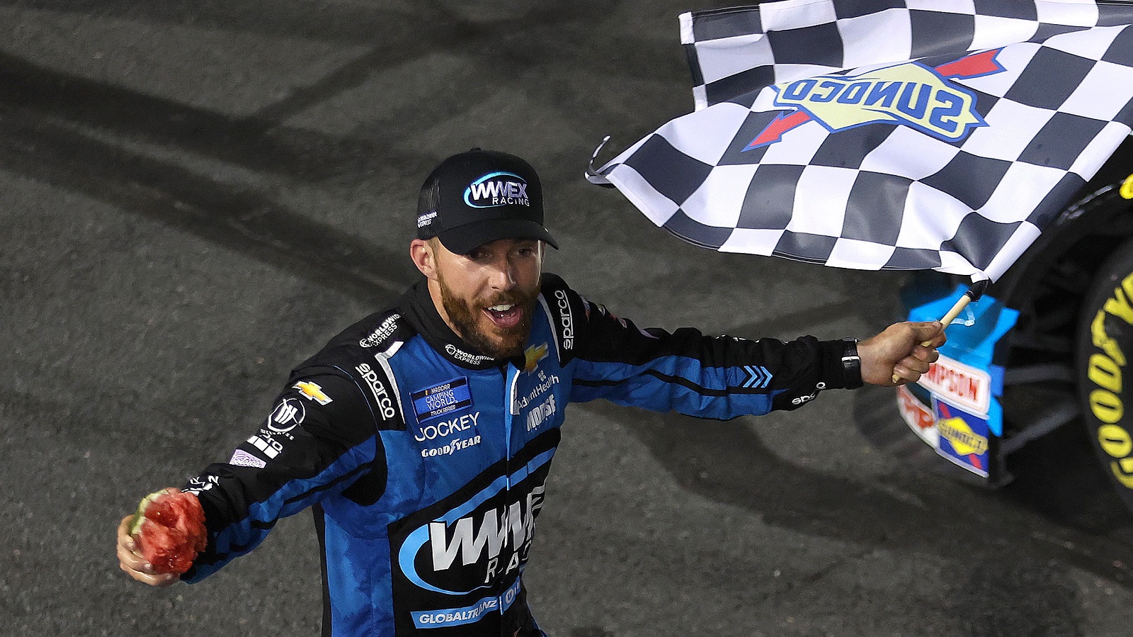 Ross Chastain celebrates with the checkered flag after winning the NASCAR Camping World Truck Series North Carolina Education Lottery 200 at Charlotte Motor Speedway on May 27, 2022.
