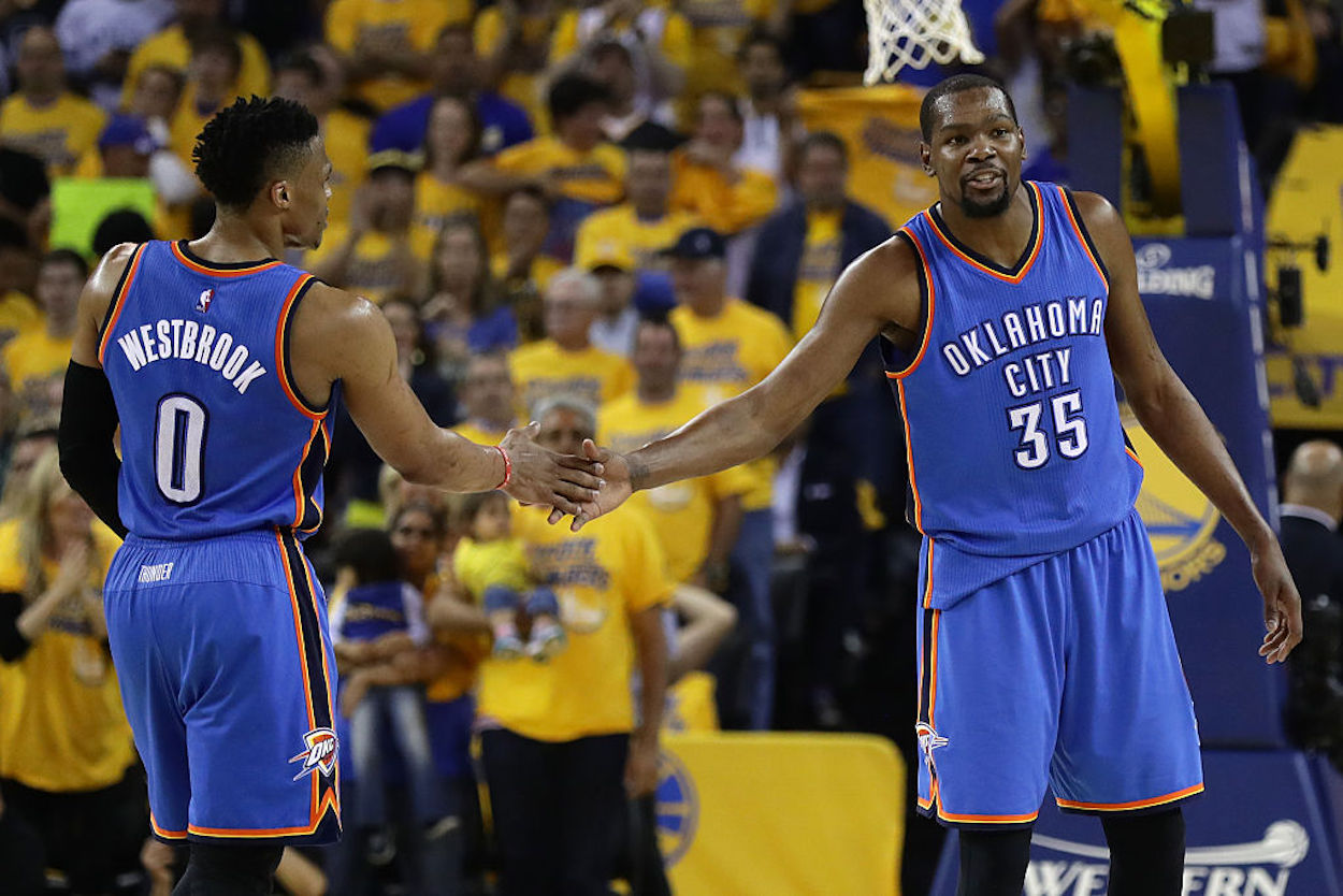 Russell Westbrook (L) and Kevin Durant (R) high five during their time as Oklahoma City Thunder teammates.