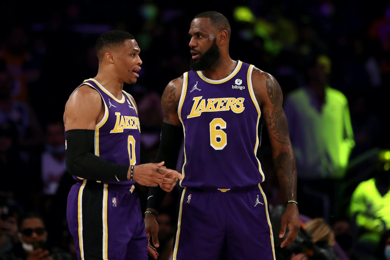 Russell Westbrook and LeBron James speak during a game.