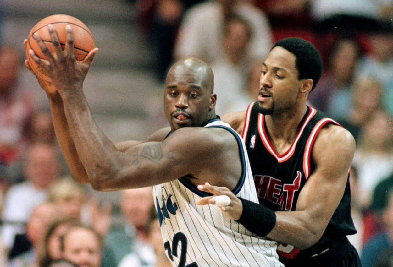 Orlando Magic center Shaquille O'Neal (L) takes control of a Magic rebound from Miami Heat center Alonzo Mourning (R) during the first period of their NBA game before he left for the LA Lakers.