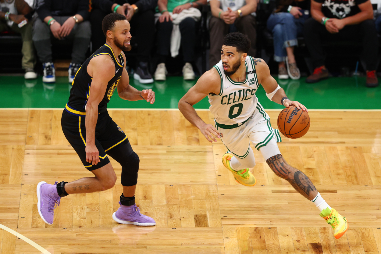 Jayson Tatum of the Boston Celtics drives past Stephen Curry of the Golden State Warriors.