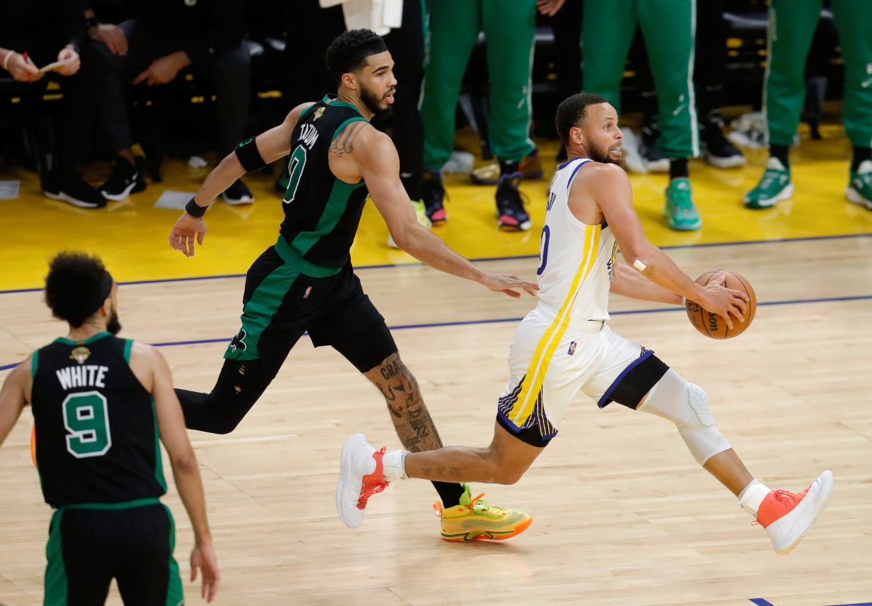Golden State Warriors' Stephen Curry heads to the hoop past Boston Celtics' Jayson Tatum.