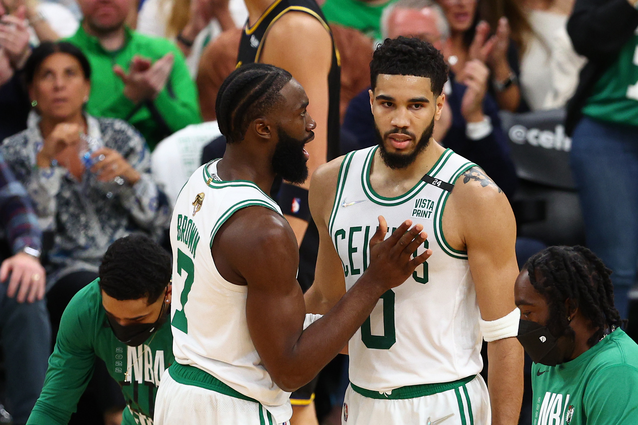 Jaylen Brown #7 and Jayson Tatum #0 of the Boston Celtics talk over a play in the second quarter.