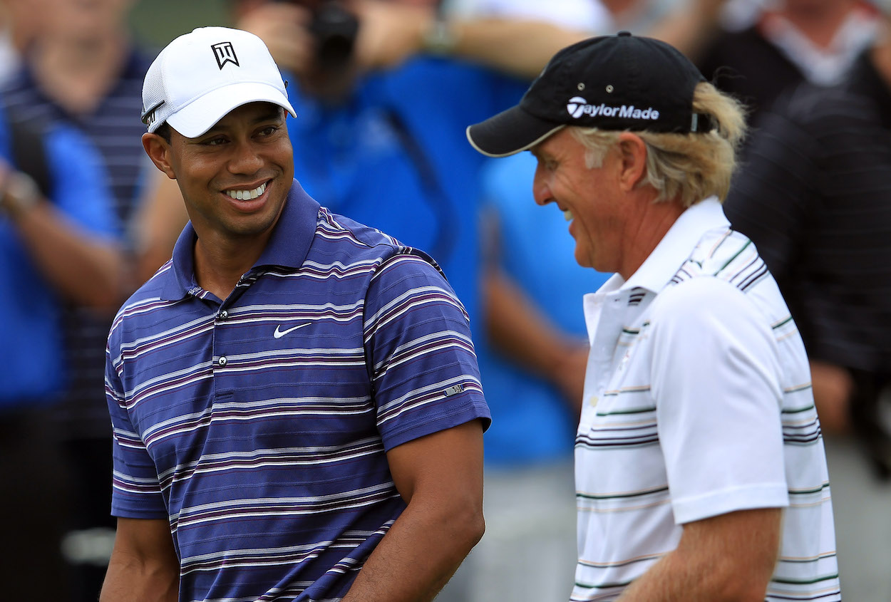 Tiger Woods laughs with Greg Norman in 2011.