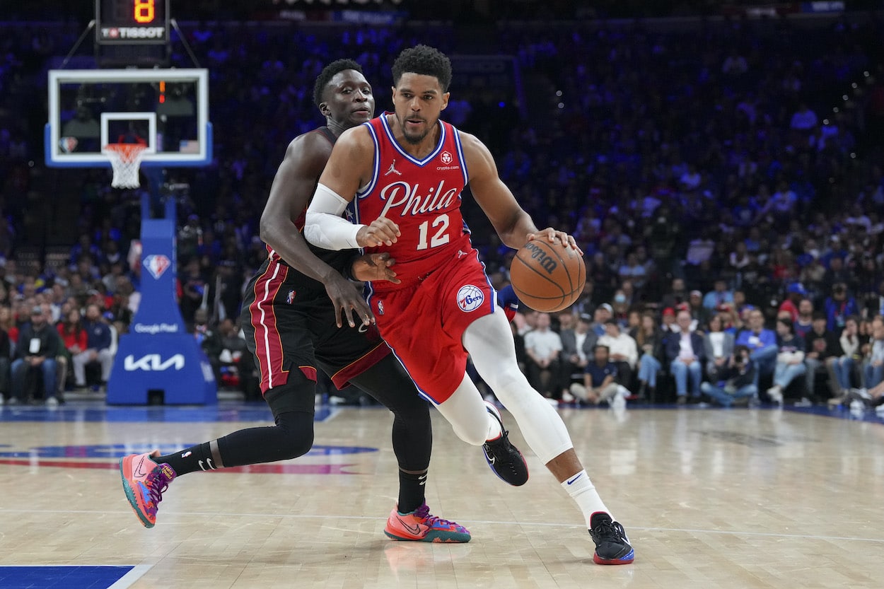 Tobias Harris dribbles past Victor Oladipo.